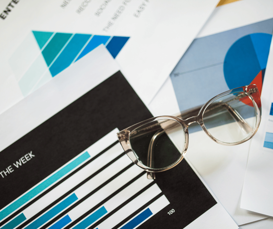 Marketing Metrics Sheets on Table with Glasses